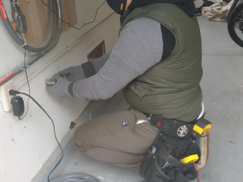 Electrician performing outlet wiring in a Kingsland garage